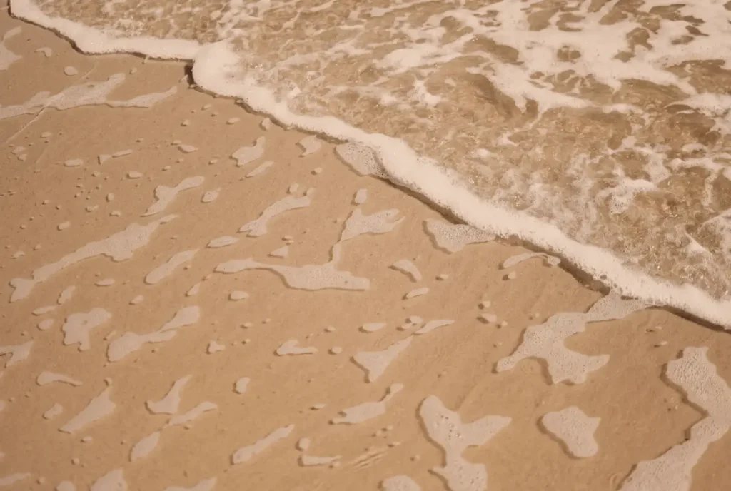 Gentle waves washing over a sandy beach on the Costa del Sol.